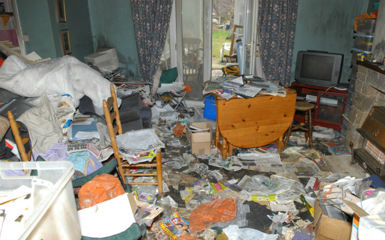 description_of_image_used_in_hoarding_webinar_living_room_covered_in_newspaper_west_yorkshire_fire_and_rescue_service